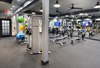 A gym with weights and other exercise equipment in a fitness center